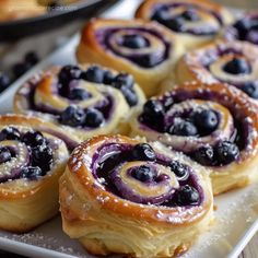 blueberry rolls on a plate with powdered sugar