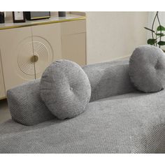 a couch with two pillows sitting on top of it