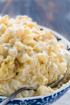 a blue and white bowl filled with macaroni salad