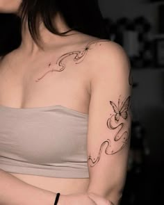 a woman with a butterfly tattoo on her left arm and right arm behind her back