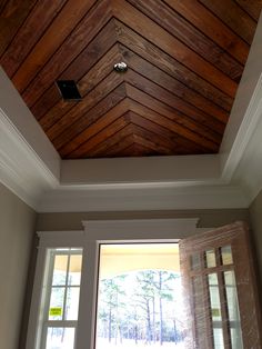 a room with two windows and a wooden ceiling