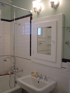 a bathroom with a sink, mirror and bathtub