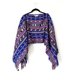 This lightweight yet cozy shawl is a modified version of our Santos Shawl. With the handmade fringe along the sleeves and the cropped length, this shawl will give you a chic look without having to compromise comfort. Guatemala Fabric Artisan: Don Manuel & Family Handwoven in Nahuala using the traditional weaving loom Material: Artisanal fabric is 100% cotton Peru Fabric Vendor: Sandra from Aguayos Cusco Manufactured in the Andes of Peru Material: Artisanal fabric is 100% acrylic wool Sewn by: Do Blue One-size Poncho With Fringe, Blue Fringe Poncho One Size, One Size Blue Poncho With Fringe, One Size Fringe Shawl Cape, One Size Fringe Cape Shawl, Cozy Shawl, Weaving Loom, Traditional Weaving, Chic Look