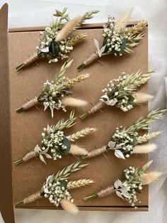 several dried flowers are arranged on a card