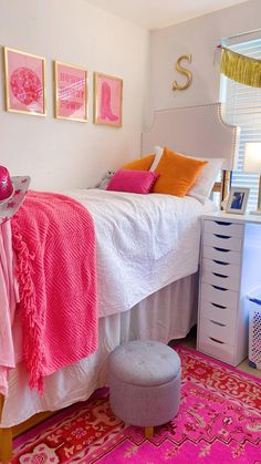 a bedroom with pink and orange decor on the walls