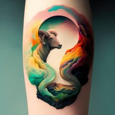 a colorful tattoo with a ram on it's leg and mountains in the background