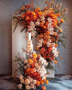 an arrangement of flowers arranged around a candle