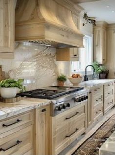 a kitchen with wooden cabinets and marble counter tops