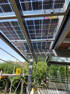 the inside of a house with solar panels on it's roof and glass walls