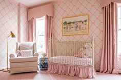 a baby's room with pink and white wallpaper