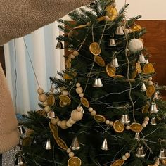 a small christmas tree decorated with gold and silver ornaments