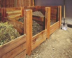 several wooden boxes filled with dirt and grass