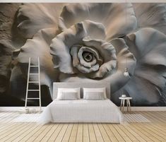 a bedroom with a large flower on the wall and a ladder in front of it