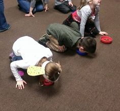 several children playing with frisbees on the floor