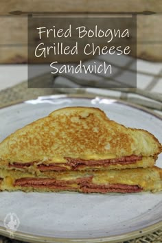 a grilled cheese sandwich on a plate with the words fried bologna grilled cheese sandwich