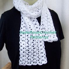 a white crocheted scarf on top of a mannequin