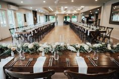 the tables are set with place settings and flowers on them for an elegant wedding reception