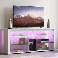 a flat screen tv sitting on top of a white entertainment center