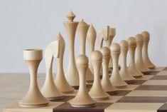 a wooden chess board with several pieces on it