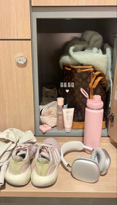 an open cabinet with shoes, handbags and other items