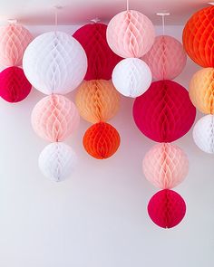 there are many different colored balls hanging from the ceiling