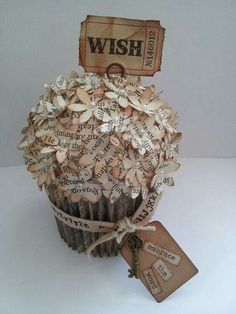 a cupcake made out of newspaper paper with a wish tag on the top that says,