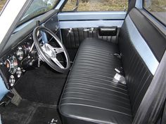 the interior of an old car with black leather seats