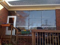 an outside view of a house with large glass doors and wooden railings on the front porch