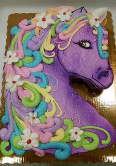 a cake shaped like a unicorn with flowers on it