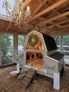 a chicken coop with a chandelier hanging from the ceiling