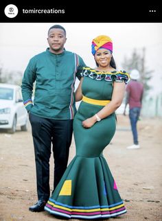 two people standing next to each other wearing green dresses