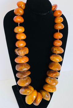 Iris Apfel Style necklace made with large copal beads, with sterling vermeil toggle clasp.   Measuring 35 inches in length with the largest bead being 2.5 inches in diameter.   The weight of the necklace is 2.5 pounds. Luxury Amber Carnelian Beaded Necklaces, Luxury Amber Oval Necklaces, Large Beaded Necklaces, Amber Oval Beads Single Strand Necklace, Amber Round Beaded Jewelry, Round Amber Jewelry With Large Beads, Amber Single Strand Necklace With Oval Beads, Amber Jewelry With Large Round Beads, Amber Jewelry With Large Beads