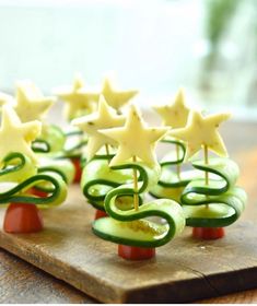 cucumber and cheese christmas trees on a cutting board