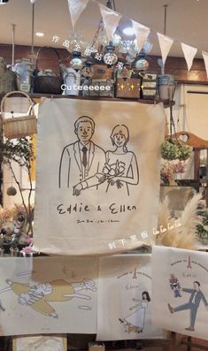 there are many signs on display in the store window, including one with an image of a bride and groom