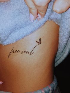 a woman's stomach with the word free soul written on it and a butterfly