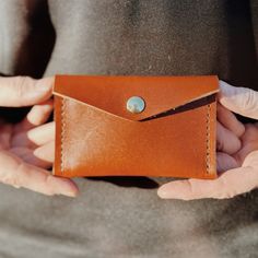 Introducing our “Mini” Willow wallet! The smaller, card holder version of our Willow Wallet, we constructed this beauty with three leather options; a beautiful, rust-colored leather, a black bridle leather, and a brown, oil-tanned leather. The mini card holder is made up of 2 pockets, both of which securely hold cash & cards, without movement (We’ve tested it for you), stitched with heavy-duty upholstery thread. Made by us, here in the USA. Watch the video to see some of the many steps involved Cognac Wallet With Interior Card Slots As Gift, Cognac Wallet With Interior Card Slots For Gift, Versatile Brown Wallet With Card Slots, Cognac Leather Wallets For Gift, Brown Waxed Finish Wallet For Everyday Use, Brown Waxed Finish Wallet For Everyday, Brown Waxed Finish Wallets For Everyday, Brown Waxed Everyday Wallets, Brown Leather Card Holder With Waxed Finish