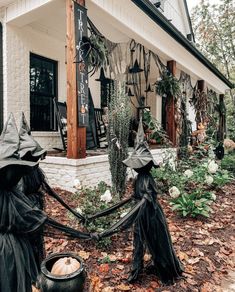 two black witches holding hands in front of a house