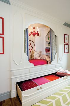 a mirror that is on the side of a wall above a bed in a room