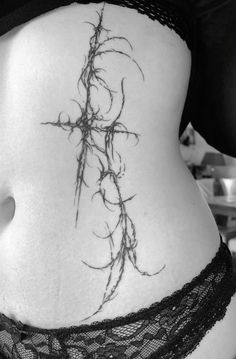 a woman's stomach with vines on it and the bottom part of her belly