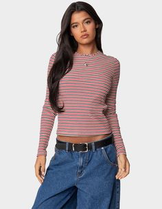 This Striped Top Gives The Perfect Twist On A Closet Staple. With Its Flattering Fitted Silhouette, It's A Versatile Piece That Will Become An Instant Go-To. T-Shirt. Long Sleeves. Striped Pattern. Ribbed Fabric. 45% Cotton, 45% Polyester, 10% Spandex. Model Wears Size S. Model Height Is 5'8. Item Care: Machine Wash At Maximum 30ºc, Do Not Bleach, Do Not Tumble Dry, Iron At A Maximum Of 110ºc, Do Not Dry Clean. | Edikted Corina Ribbed Stripey Long Sleeve Tee Long Sleeve Shirt Women, Chino Pants Women, Wwe T Shirts, Girls Blouse, Womens Long Sleeve Shirts, Fitted Silhouette, Ribbed Fabric, Striped Long Sleeve, Model Height