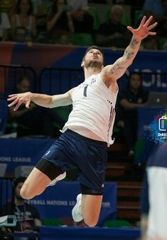 a man jumping in the air to hit a tennis ball