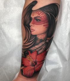 a woman's leg with tattoos and flowers on it