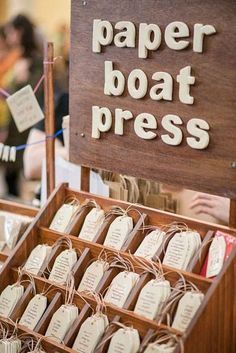 a wooden box filled with paper boat press