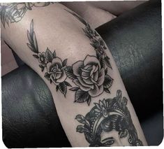 a woman's leg with roses on it and a clock in the middle of her arm