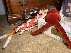 two stuffed animals are on the floor next to a drawer and other items that have been placed around them