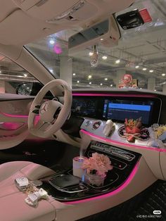 the interior of a car is decorated with pink lights