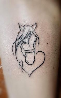 a woman's tattoo with a horse head and heart on her right side ribcage