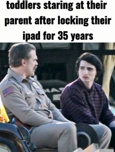 two men sitting next to each other in front of a fire hydrant with the caption that reads, when kids start at their parents staring at their parent after looking their ipad for 35 years