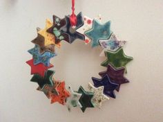 an ornament made out of ceramic stars hangs on the wall