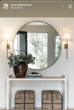 a mirror and two stools in front of a table with a potted plant on it